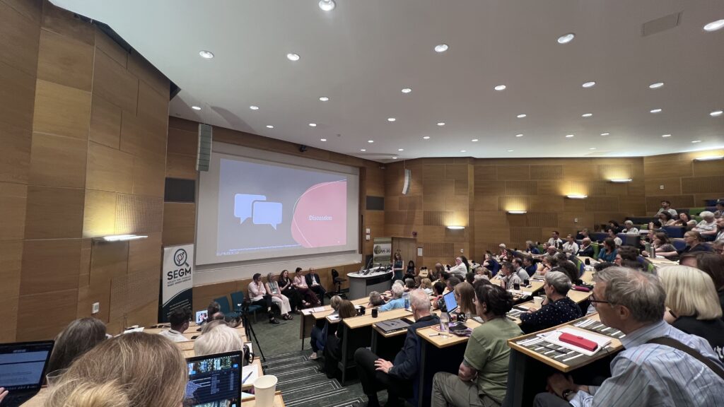 A wide shot of the conference hall during a different session.